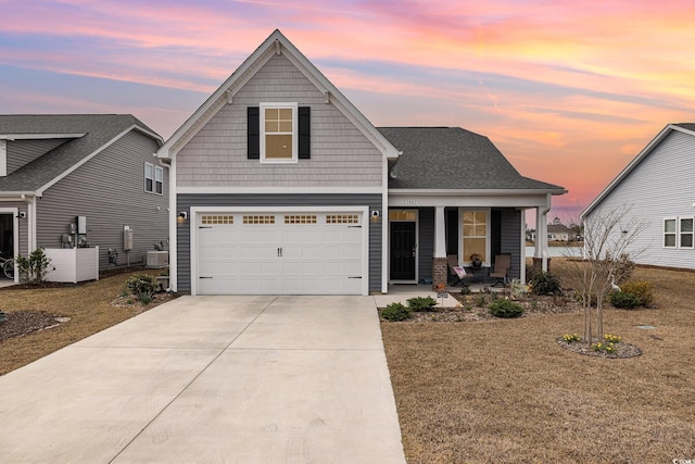 1881 Moonseed Dr, Longs, SC 29568 - view of front facade with a porch, concrete driveway, a garage, a front lawn, and central air condition unit