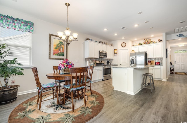 1881 Moonseed Dr, Longs, SC 29568 - dining room with a chandelier, light wood-style floors, baseboards, and recessed lighting