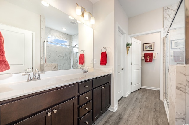 1881 Moonseed Dr, Longs, SC 29568 - full bathroom with double vanity, a marble finish shower, wood finished floors, and baseboards