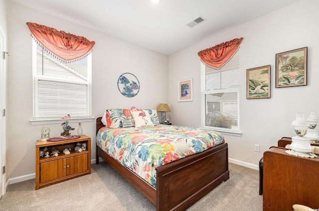 1881 Moonseed Dr, Longs, SC 29568 - bedroom featuring light colored carpet, multiple windows, and baseboards