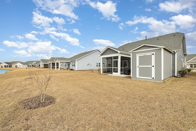 1881 Moonseed Dr, Longs, SC 29568 - rear view of property featuring a sunroom, a lawn, and a shingled roof