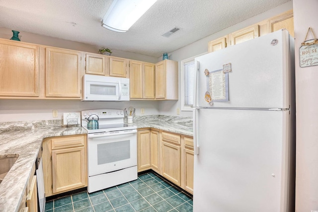 kitchen featuring visible vents, light brown cabinets, light countertops, white appliances, and a textured ceiling