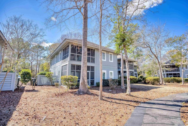 view of side of property with a sunroom