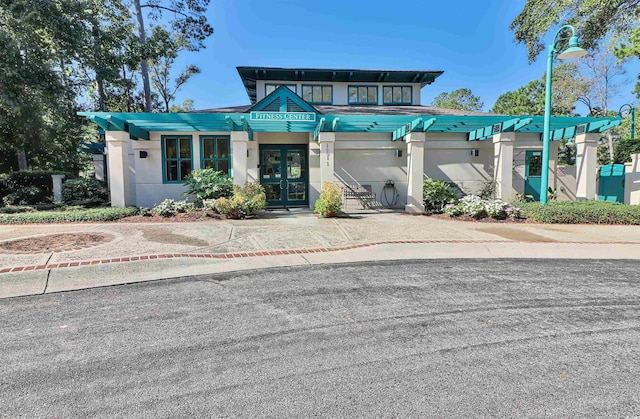 view of front of home with french doors and stucco siding