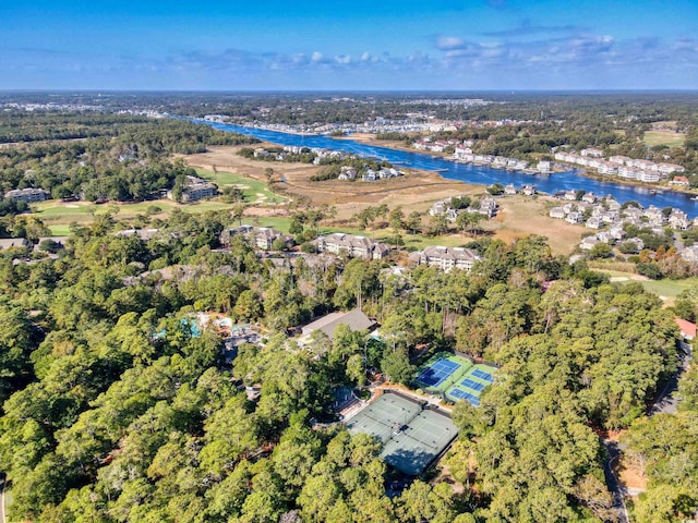 drone / aerial view featuring a forest view and a water view