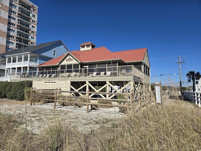 rear view of property with metal roof