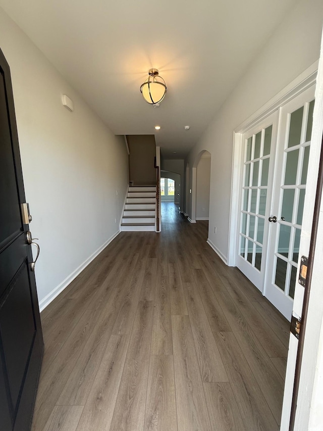 4008 Bucolic Loop, Myrtle Beach, SC 29588 - corridor featuring arched walkways, wood finished floors, stairs, and baseboards