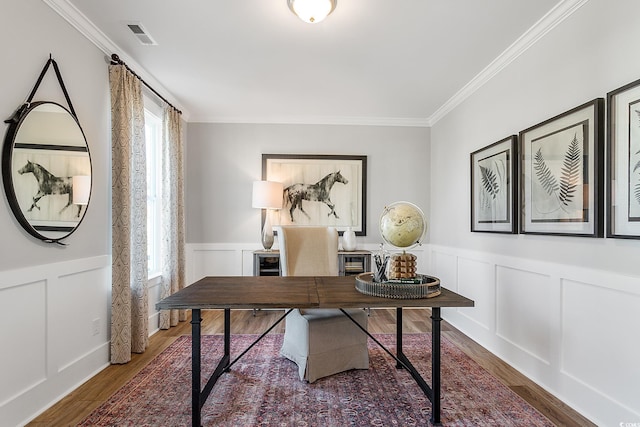 office featuring a decorative wall, wainscoting, ornamental molding, and wood finished floors