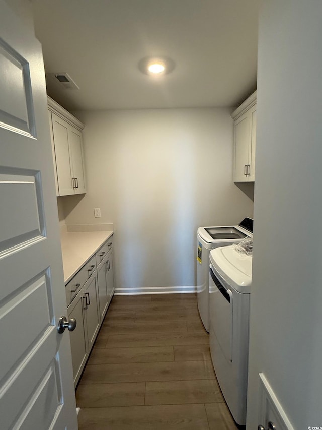 4008 Bucolic Loop, Myrtle Beach, SC 29588 - washroom with cabinet space, washing machine and clothes dryer, dark wood-type flooring, and baseboards