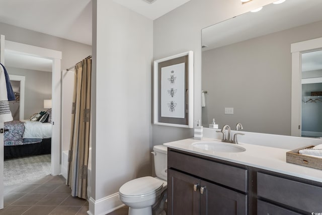 bathroom featuring tile patterned floors, a shower with curtain, toilet, baseboards, and vanity