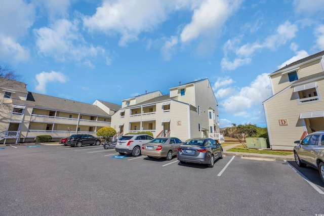 uncovered parking lot featuring a residential view