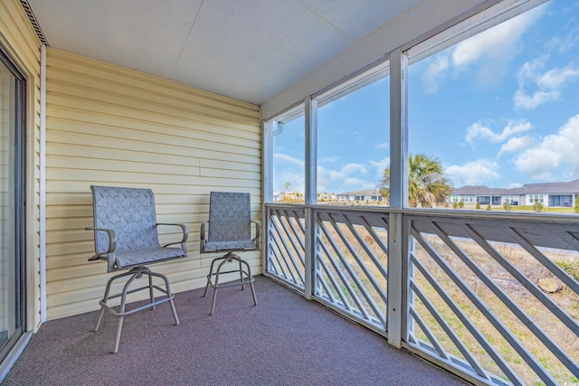 sunroom featuring a residential view