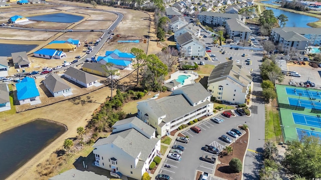 drone / aerial view with a water view and a residential view