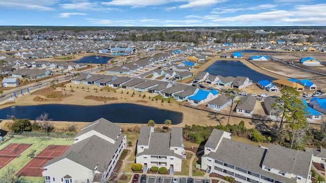 drone / aerial view with a residential view and a water view