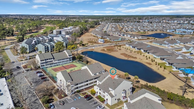 drone / aerial view with a residential view and a water view