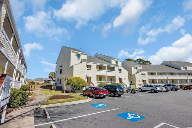 view of property with a residential view and uncovered parking