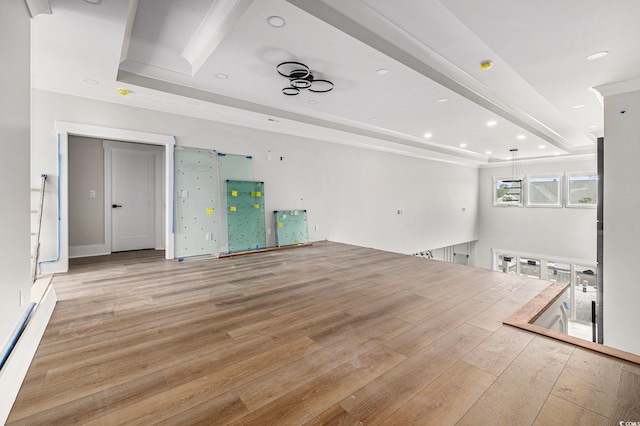 1217 Bentcreek Ln, Myrtle Beach, SC 29579 - unfurnished living room featuring light wood finished floors, a raised ceiling, a baseboard heating unit, recessed lighting, and crown molding