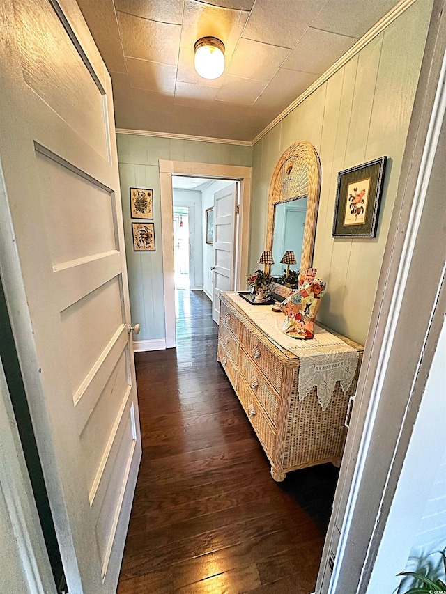 hallway with dark wood finished floors and crown molding