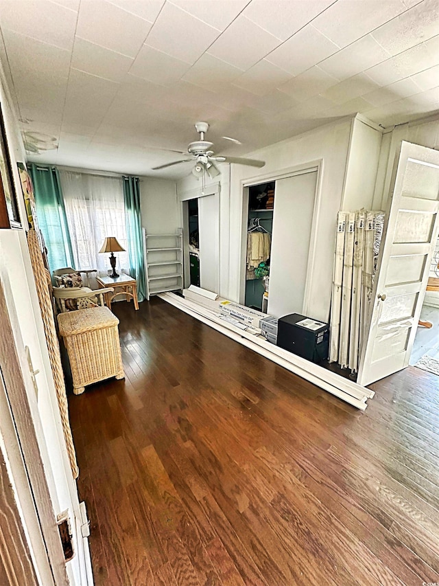 interior space with a ceiling fan and wood finished floors