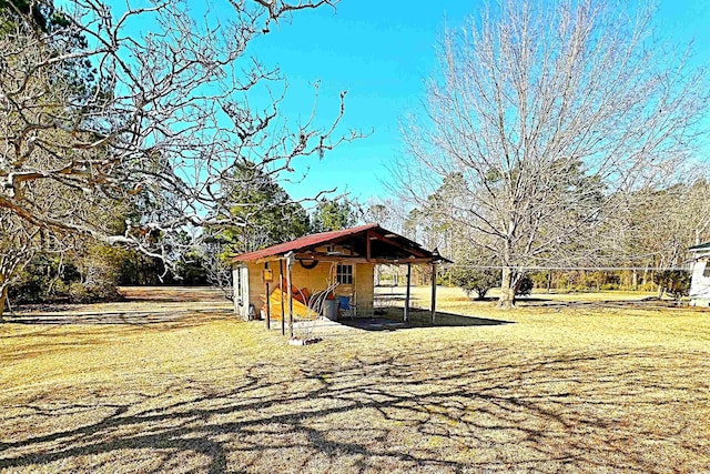 view of side of property featuring a yard and an outdoor structure