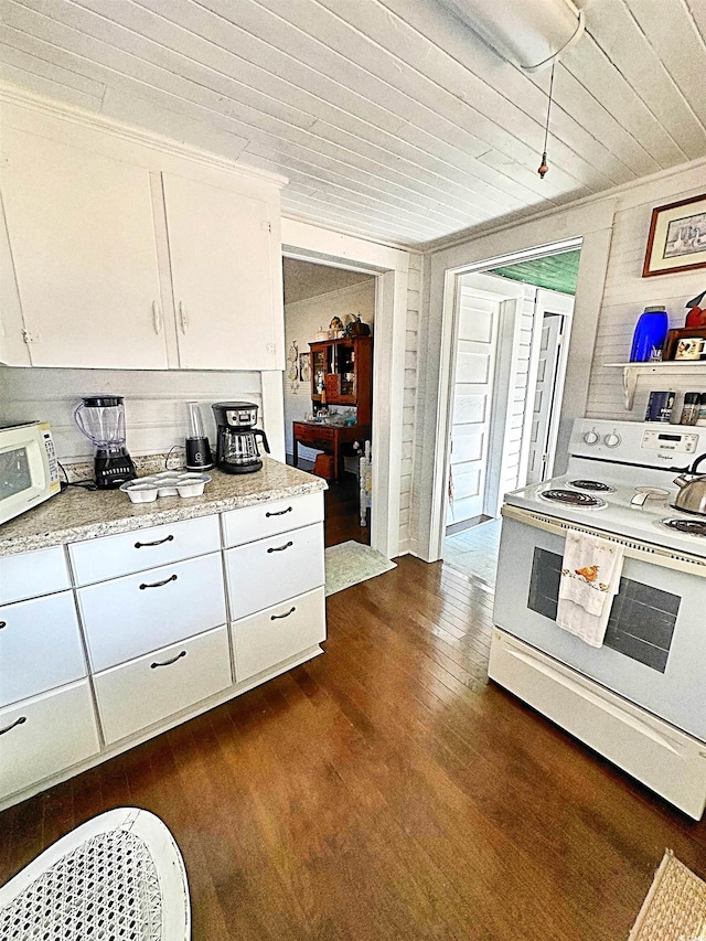 kitchen featuring dark wood-style floors, light countertops, white appliances, and white cabinets