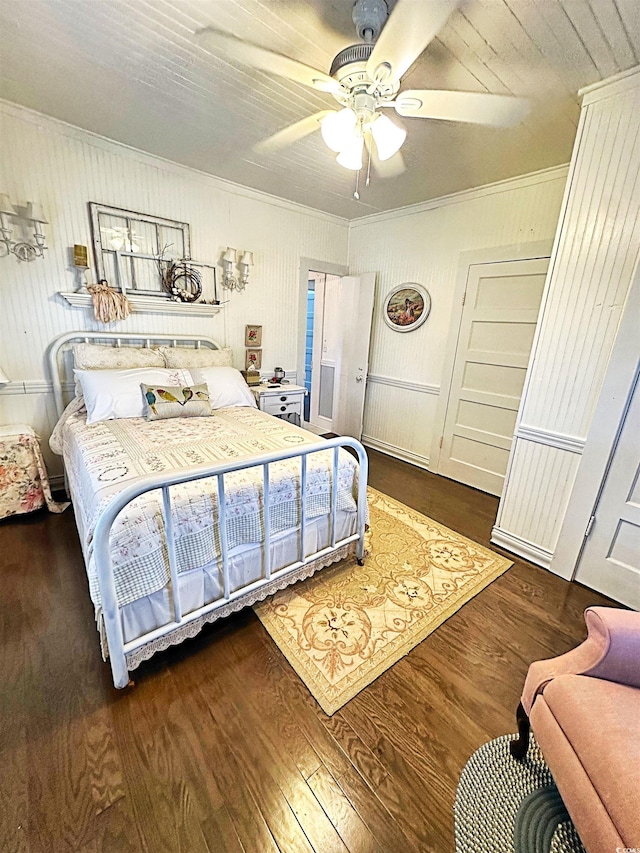 bedroom with a ceiling fan, ornamental molding, and wood finished floors