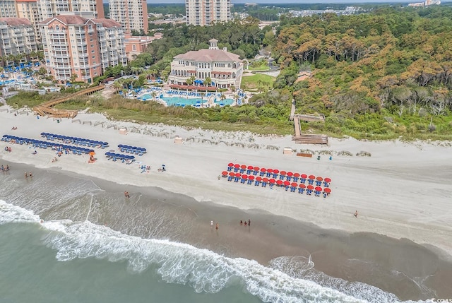 birds eye view of property with a water view, a view of city, and a view of the beach