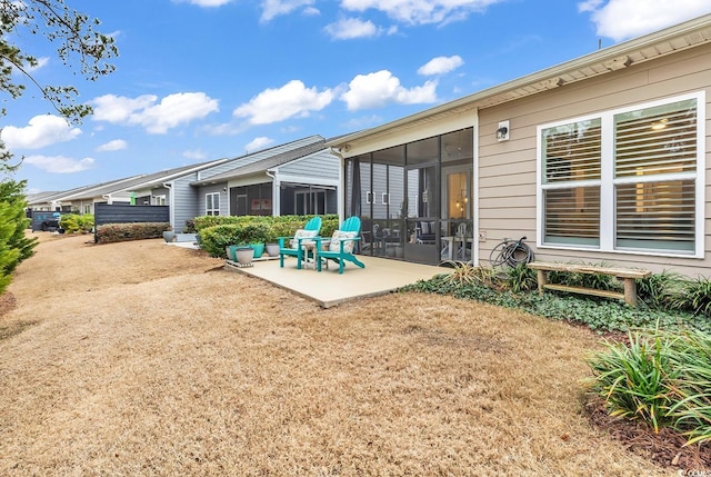 back of property featuring a patio area and a sunroom