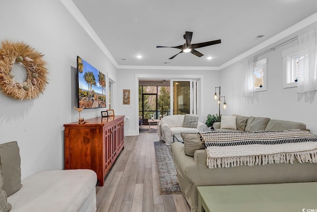 bedroom featuring multiple windows, wood finished floors, crown molding, and access to outside