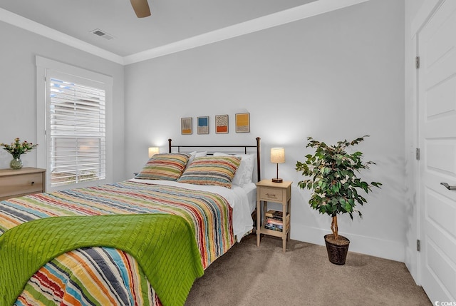 bedroom with visible vents, crown molding, baseboards, carpet, and a ceiling fan