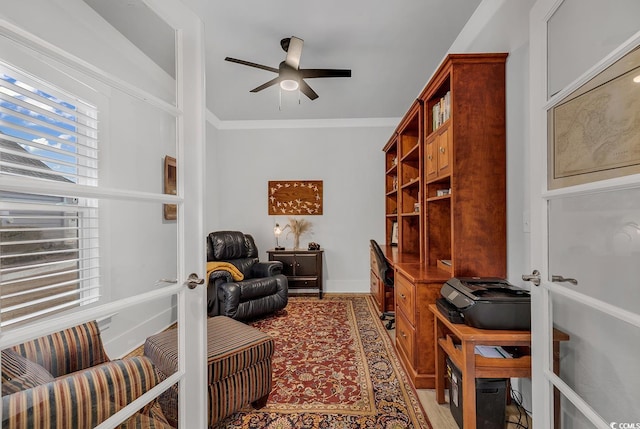 home office featuring crown molding, baseboards, and ceiling fan