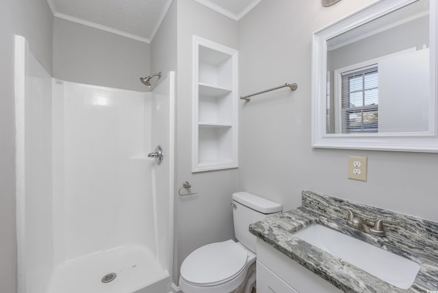 full bathroom featuring toilet, a stall shower, a textured ceiling, crown molding, and vanity