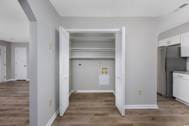 washroom featuring visible vents, washer hookup, laundry area, wood finished floors, and arched walkways