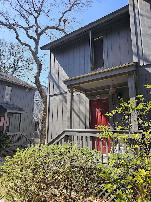 view of exterior entry with board and batten siding