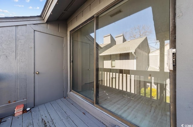 wooden terrace featuring visible vents