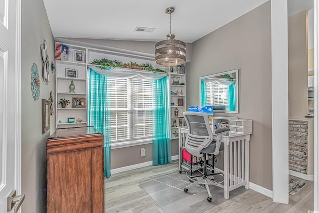 office featuring visible vents, baseboards, and wood finished floors