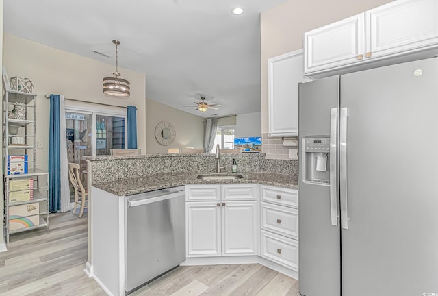 1006 Charles St, North Myrtle Beach, SC 29582 - kitchen featuring appliances with stainless steel finishes, a peninsula, white cabinetry, light wood finished floors, and recessed lighting