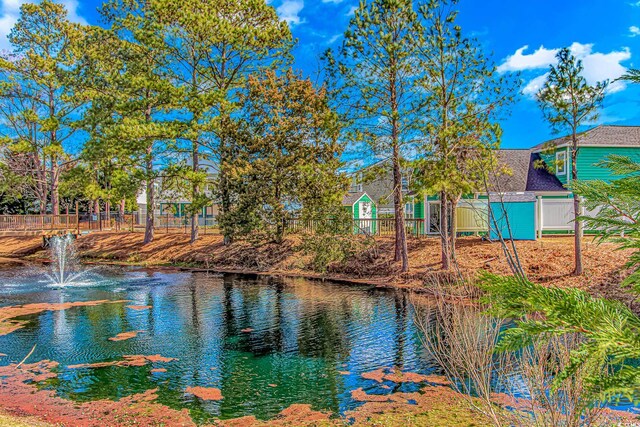 property view of water featuring fence