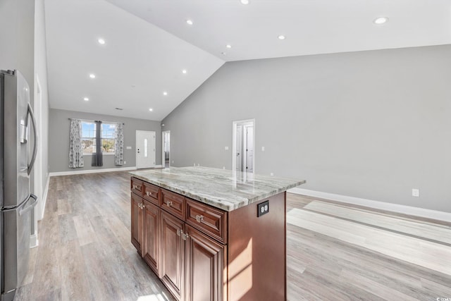 108 Silver Peak Dr, Conway, SC 29526 - kitchen with stainless steel fridge with ice dispenser, open floor plan, a center island, light wood-type flooring, and light stone countertops