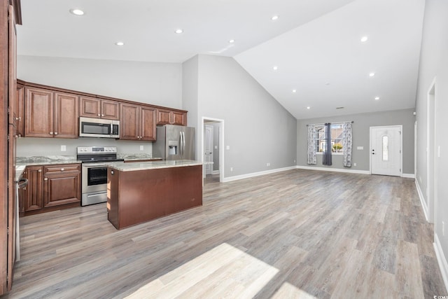 108 Silver Peak Dr, Conway, SC 29526 - kitchen featuring appliances with stainless steel finishes, high vaulted ceiling, a center island, open floor plan, and light wood-style floors