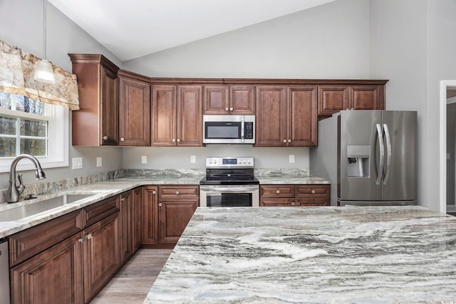 108 Silver Peak Dr, Conway, SC 29526 - kitchen with appliances with stainless steel finishes, a sink, vaulted ceiling, light wood-type flooring, and light stone countertops