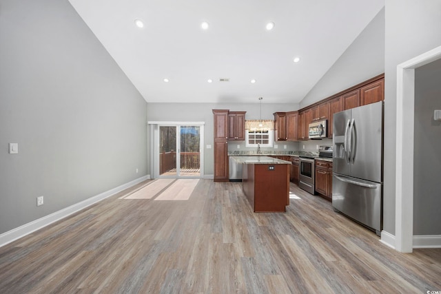 108 Silver Peak Dr, Conway, SC 29526 - kitchen featuring stainless steel appliances, lofted ceiling, a sink, a center island, and light wood-type flooring