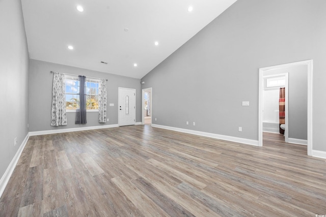 108 Silver Peak Dr, Conway, SC 29526 - unfurnished living room with high vaulted ceiling, baseboards, light wood-style floors, and recessed lighting