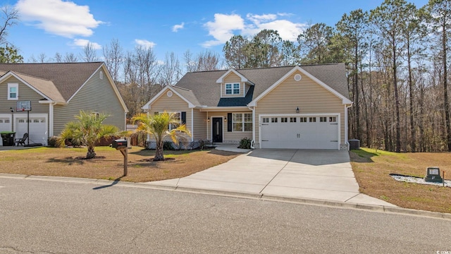 traditional-style house with a front yard, a garage, and driveway