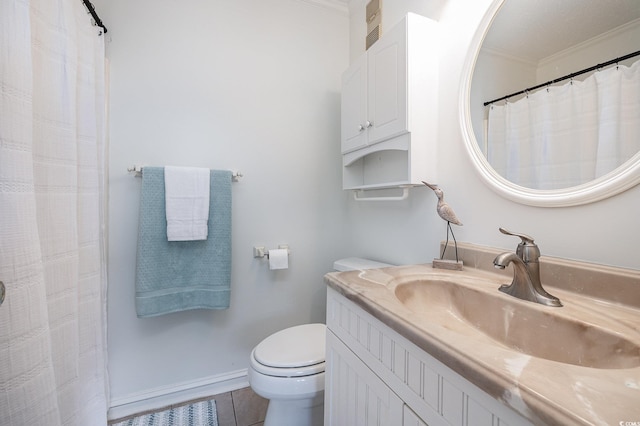 full bathroom with tile patterned flooring, crown molding, baseboards, toilet, and vanity