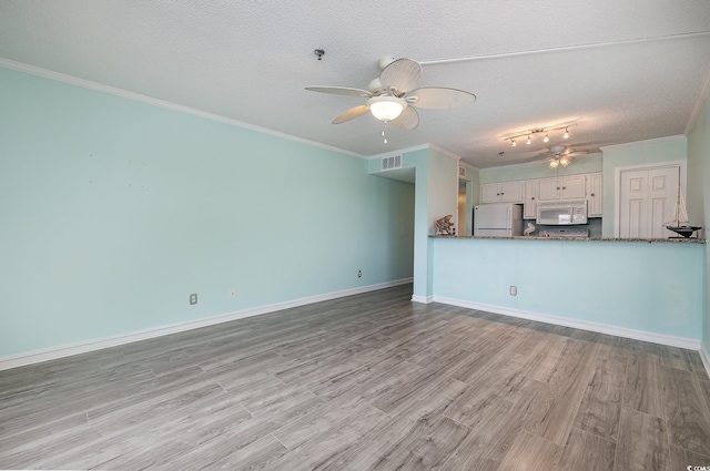 unfurnished living room featuring crown molding, a ceiling fan, light wood-type flooring, and a textured ceiling