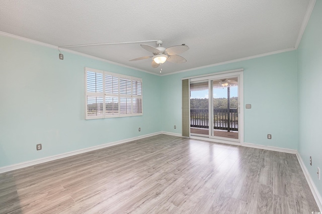 empty room with a ceiling fan, wood finished floors, and a textured ceiling