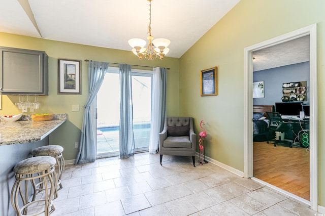 sitting room featuring vaulted ceiling, baseboards, and a notable chandelier