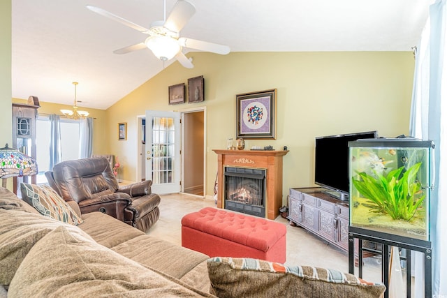 tiled living area with ceiling fan with notable chandelier, a warm lit fireplace, and vaulted ceiling