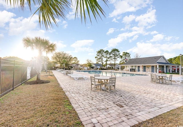 exterior space with a community pool and fence